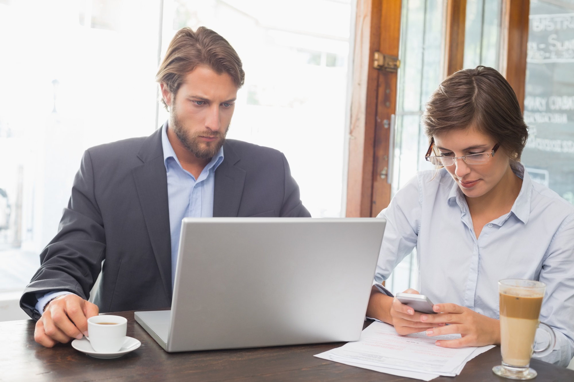 consultant and client discussing portfolio on laptop