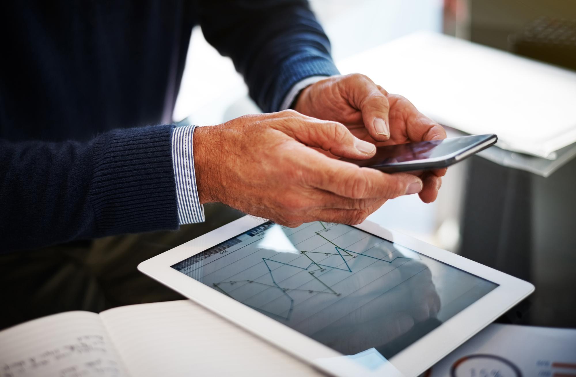 advisor hands with tablet showing charts